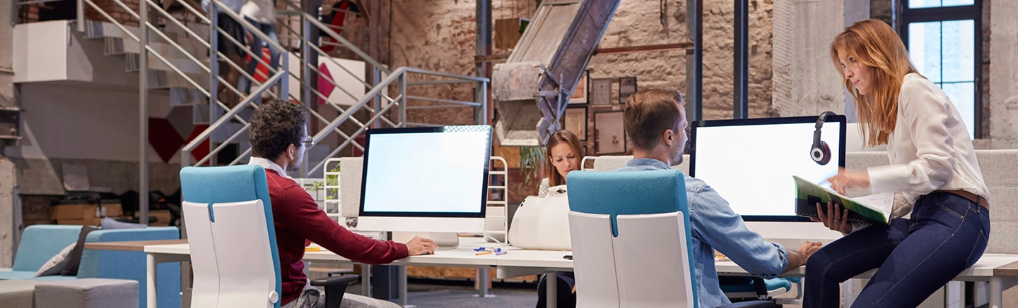 Man and woman talking at office desk