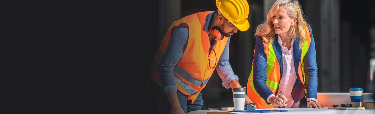 Man and woman wearing safety equipment and talking