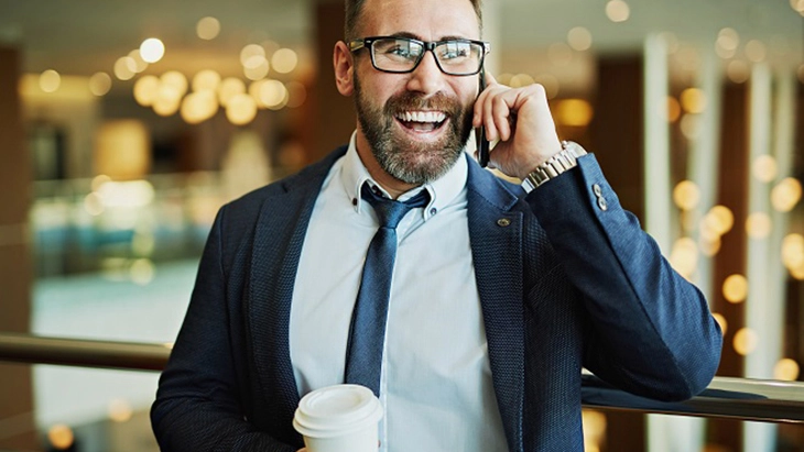 Smiling man talking on mobile