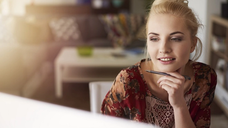 Woman smiling and resting chin on hand