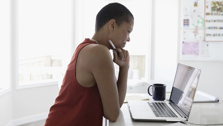 Woman at desk with laptop