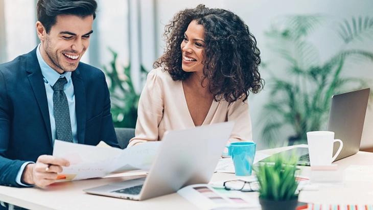 Man and woman in office looking at CV