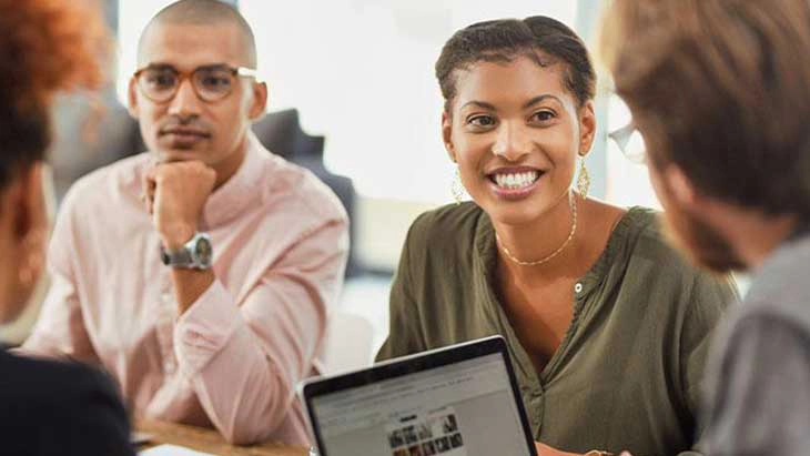 Colleagues smiling in meeting