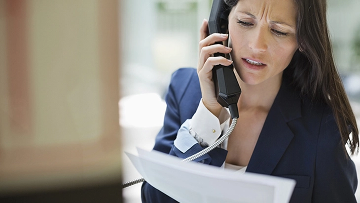 Woman talking on phone and reading report