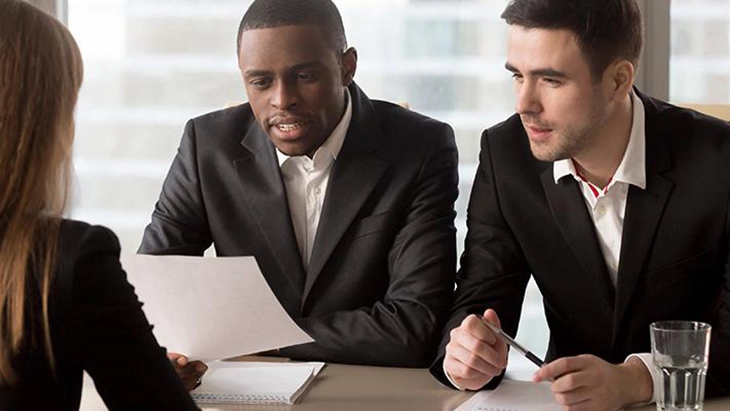 Two men interviewing job applicant