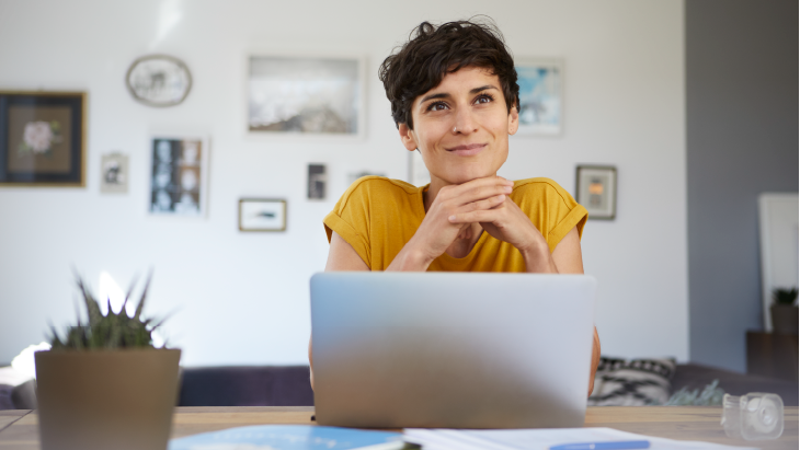 Woman smiling and using laptop