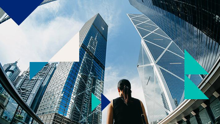 Woman walking between skyscrapers