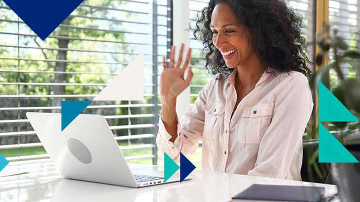 Woman in an online meeting and waving and smiling