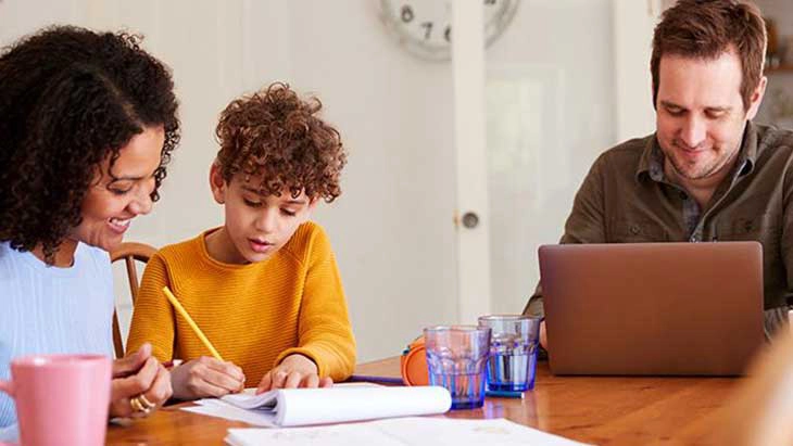 Mother, father and son working a kitchen table