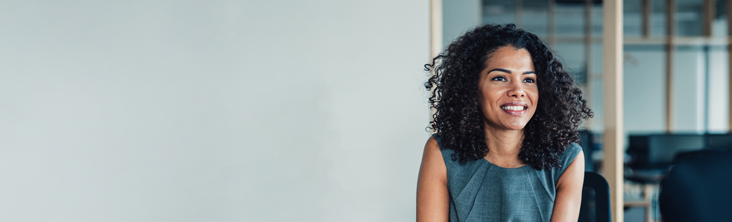 Professional seated in a modern office environment, representing career progression and new job opportunities for the Hay New Job guide.