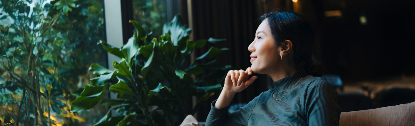 Person seated in a modern office setting beside indoor plants, representing strategic thinking and cost‑efficient workforce planning in Ireland.
